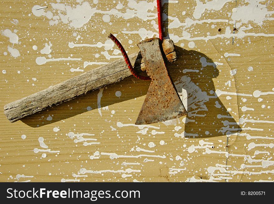 Rusty axe in the sun over a dirty background