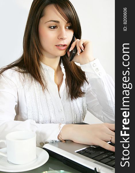 Business woman talks on a mobile telephone. Business woman talks on a mobile telephone