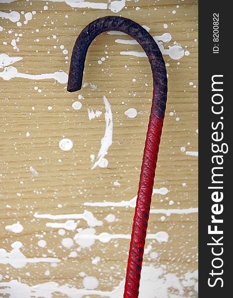 Red rod folded as a hook on a spotted background