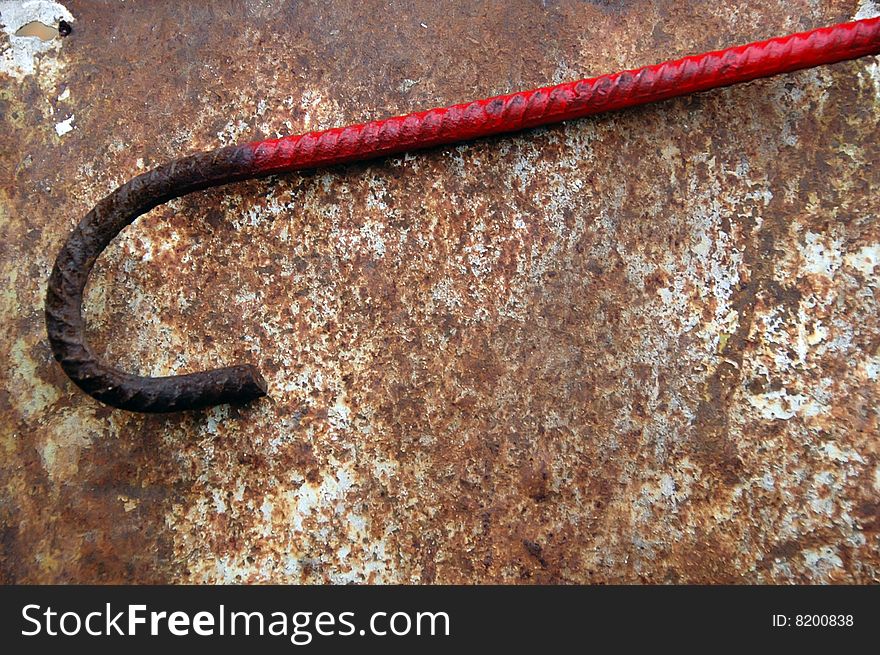 Red rusty rod folded as a hook