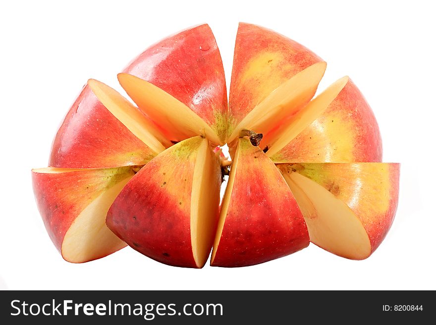 An apple is cut by lobules on a white background. An apple is cut by lobules on a white background.