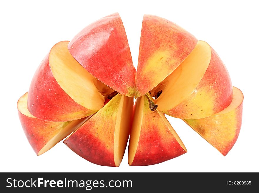An apple is cut by lobules on a white background. An apple is cut by lobules on a white background.