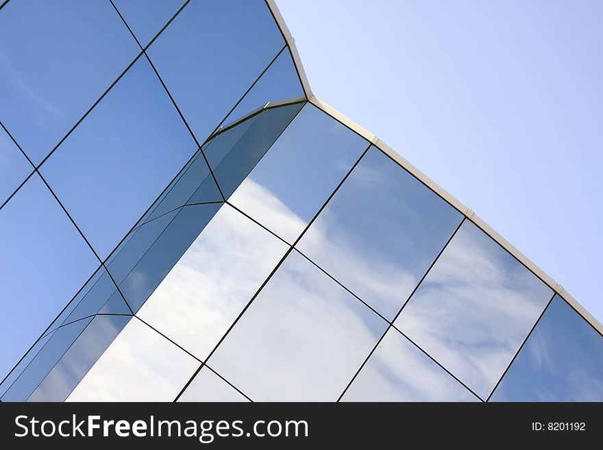 Reflections in the glass of the modern building. Reflections in the glass of the modern building.