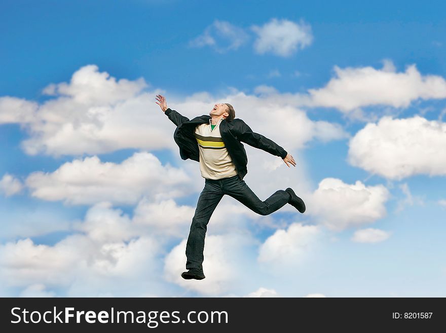 Jumping man over sky background