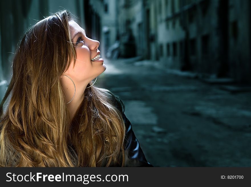 Portrait of the girl in a court yard of an old city