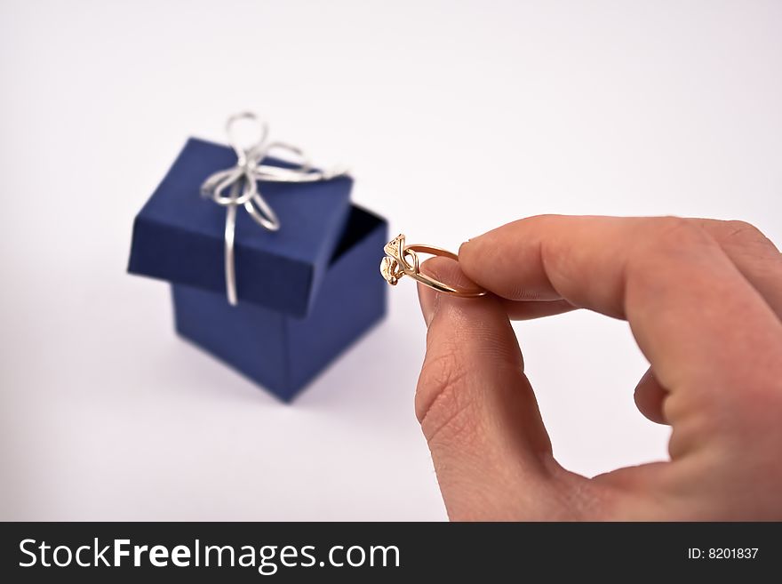 Engagement ring in man's hand.