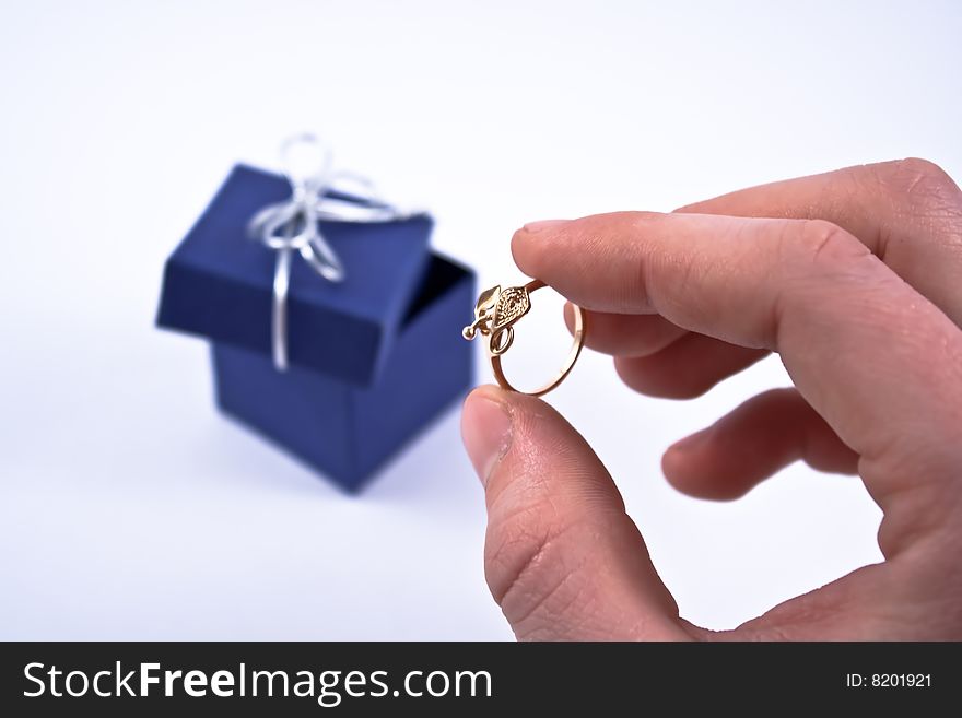 Engagement ring in man's hand.