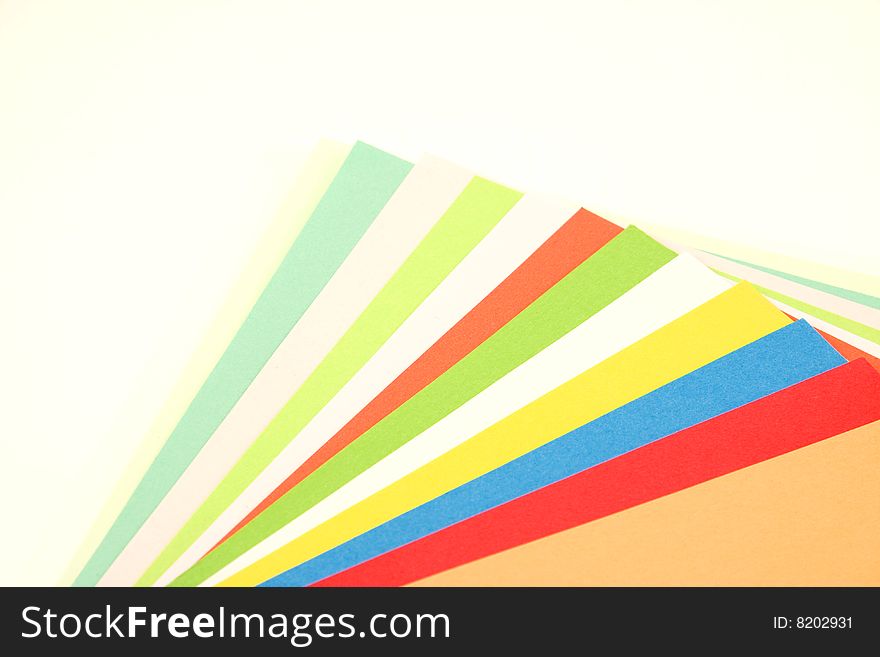 Colorful fan made of papers, isolated over white background.