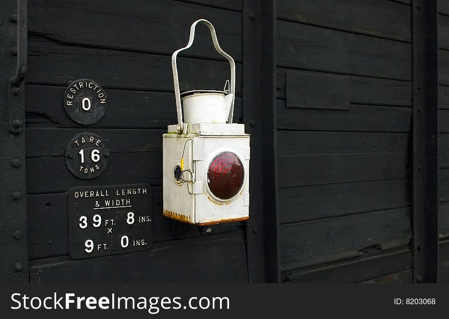 Old style lantern on the back of a vintage boxcar. Old style lantern on the back of a vintage boxcar