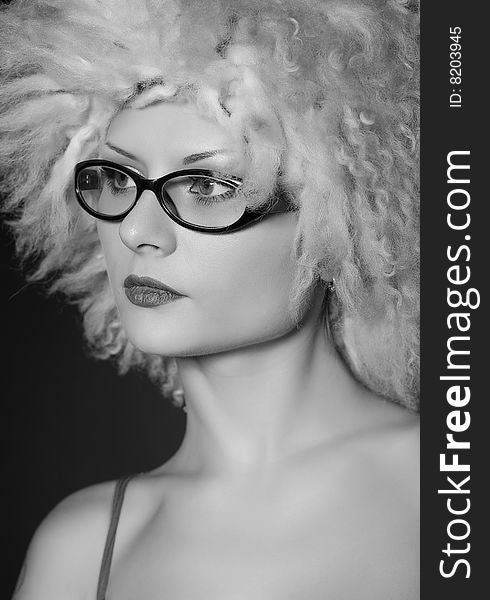 Beautiful girl in glasses and furry hat, grayscale