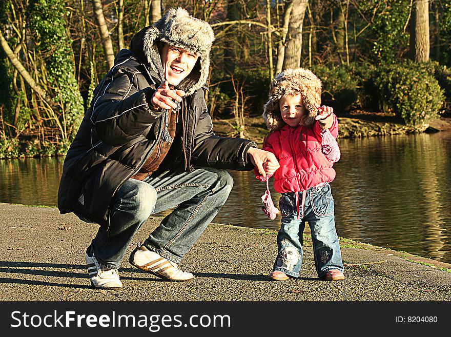 Daddy and daughter playing in park