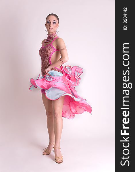 Professional dancer in pink dress, studio shot