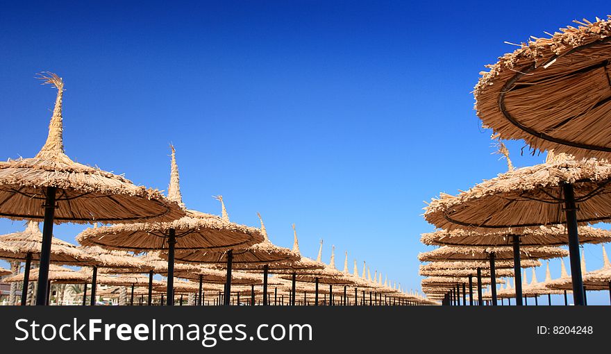 Clear, blue sky and umbrellas on the beach