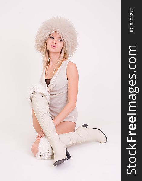 Upset girl in furry hat, studio shot