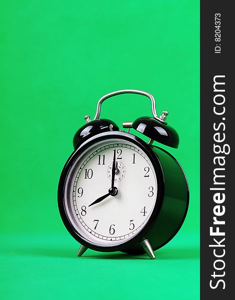 An alarm clock with green background