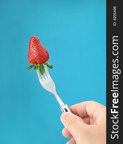 A fresh strawberry on a fork