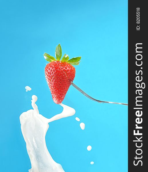 Close up of milk splash with strawberry. Close up of milk splash with strawberry