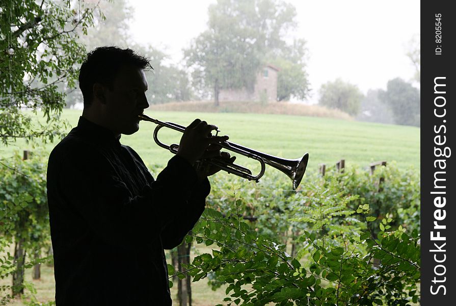 A man playing trumpet outdoor