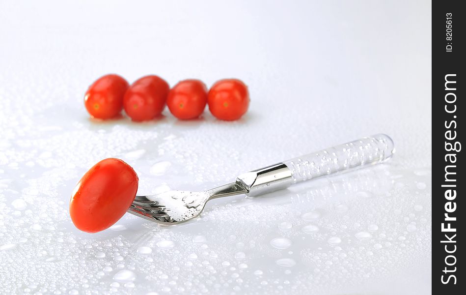 Small tomato on white background. Small tomato on white background.