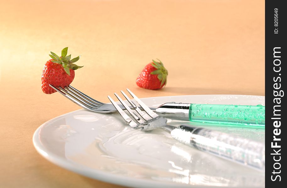 Orange background fork strawberry Dishes. Orange background fork strawberry Dishes