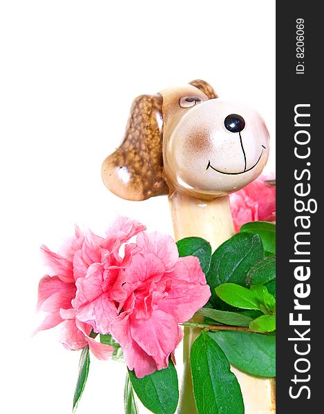 Closeup to flower in pot with dog figure isolated on white background. Closeup to flower in pot with dog figure isolated on white background.