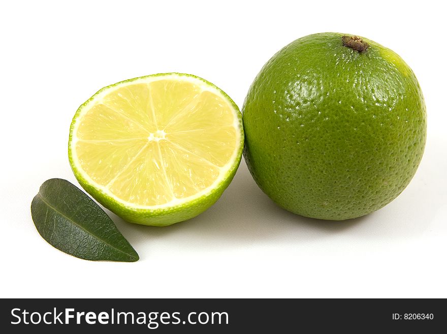 Green lime with leaf isolated on white