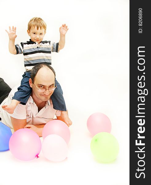 Father and son playing with balloons over white