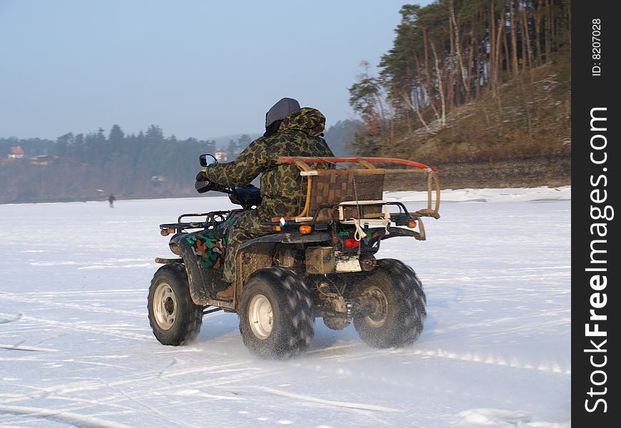 Quad riding on frozen lake. Quad riding on frozen lake