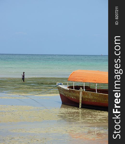 Boat and little boy on the island of zanzibar