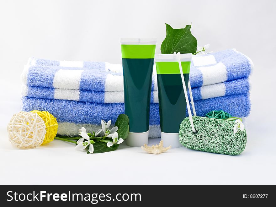 Striped towels with creams and snowdrops isolated on white background