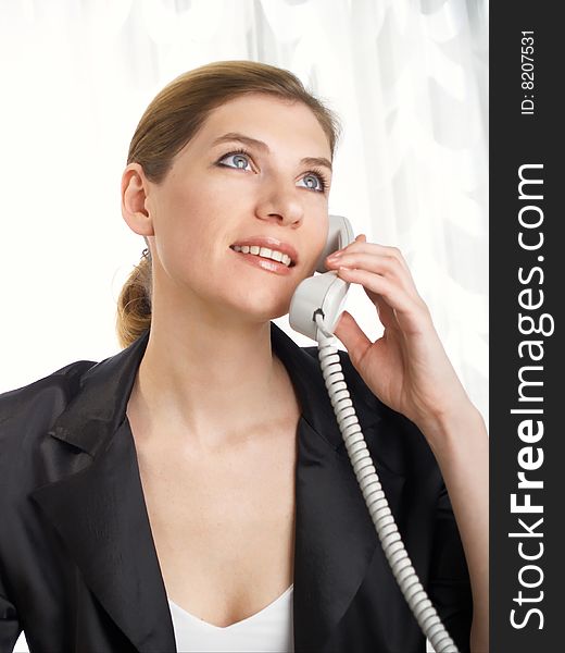Young beautiful businesswoman speaking on the telephone. Young beautiful businesswoman speaking on the telephone