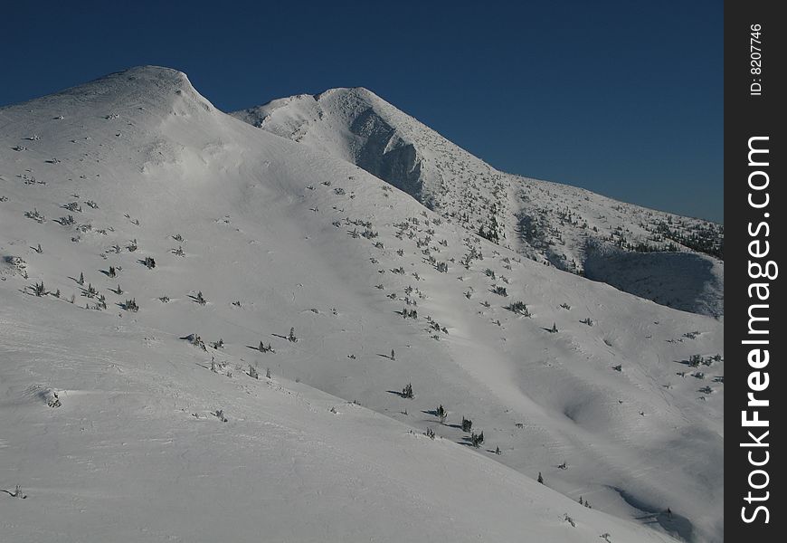 Winter season on snowy mountains