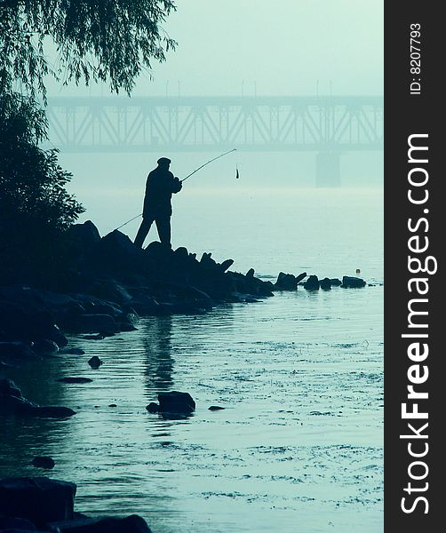Alone fisher near sunset river 1
