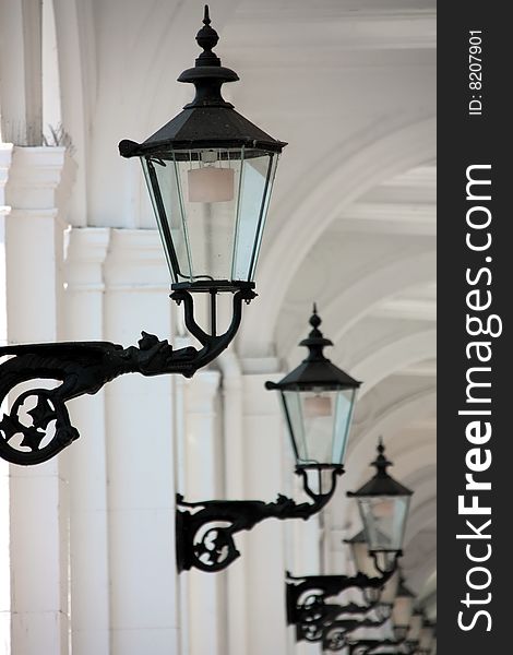 Historic lanterns aligned in a white gateway
