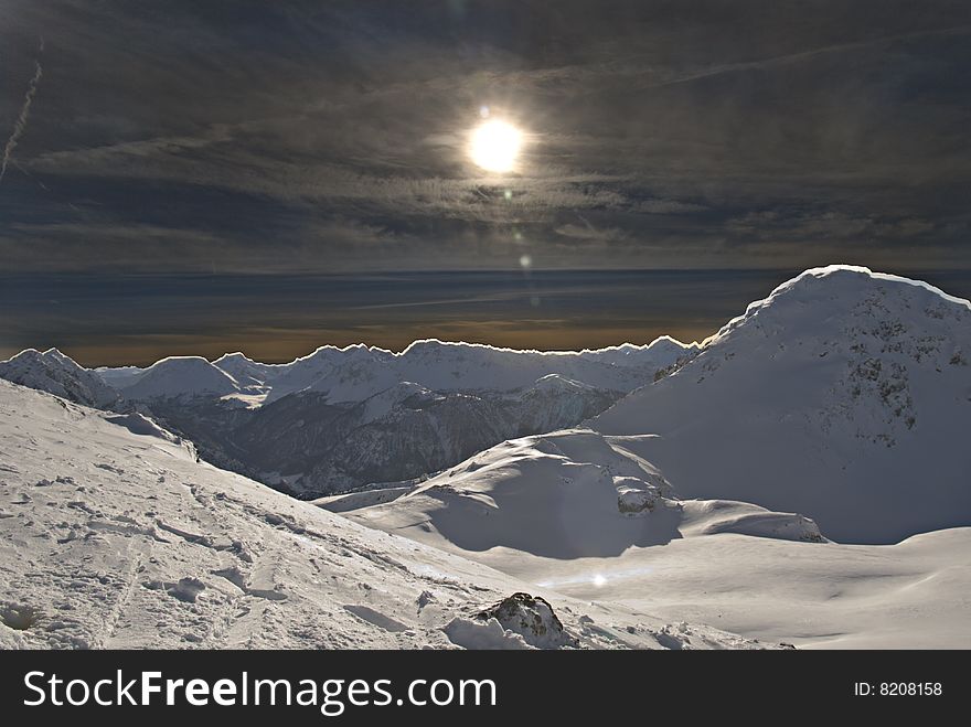 Winter sunset in high mountains and snow