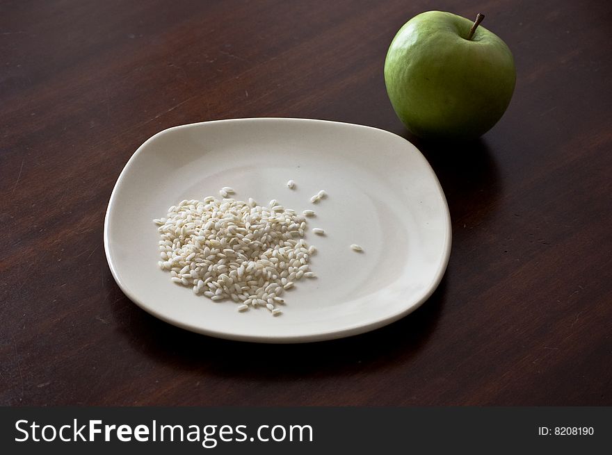 A rice dish and an apple, for an healthy diet. A rice dish and an apple, for an healthy diet