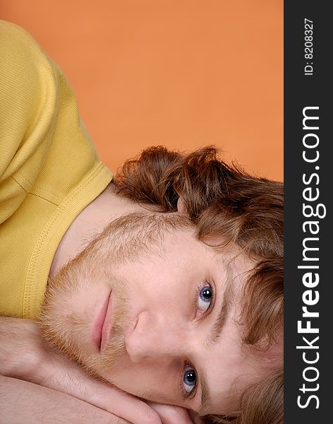 Portrait of thoughtful young man on an orange background. Portrait of thoughtful young man on an orange background