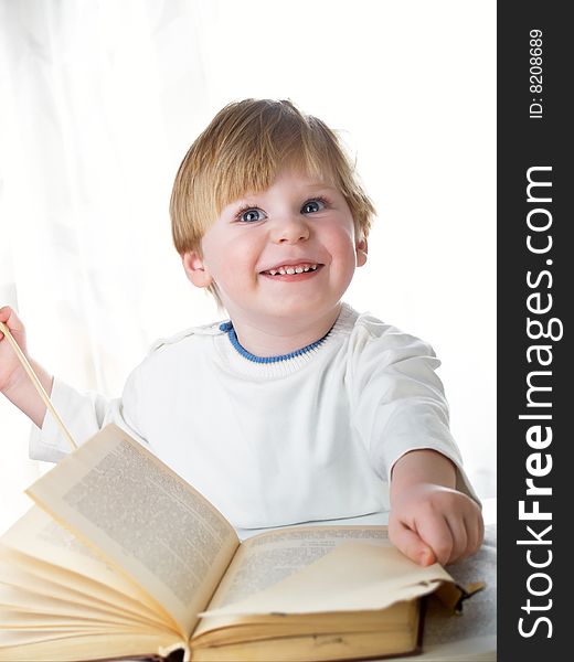 The boy with the big book in hands. The boy with the big book in hands