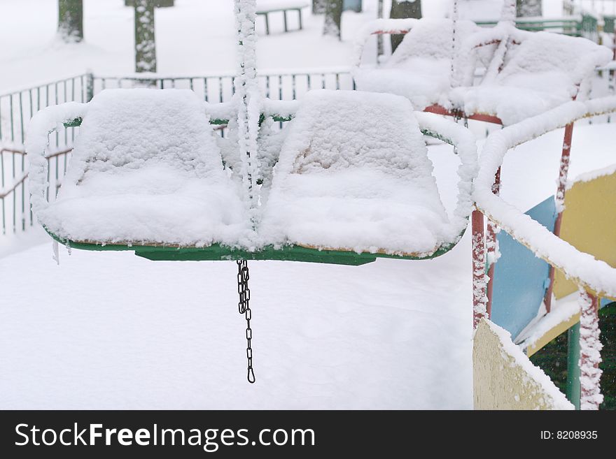 Winter scene with snowy chairs