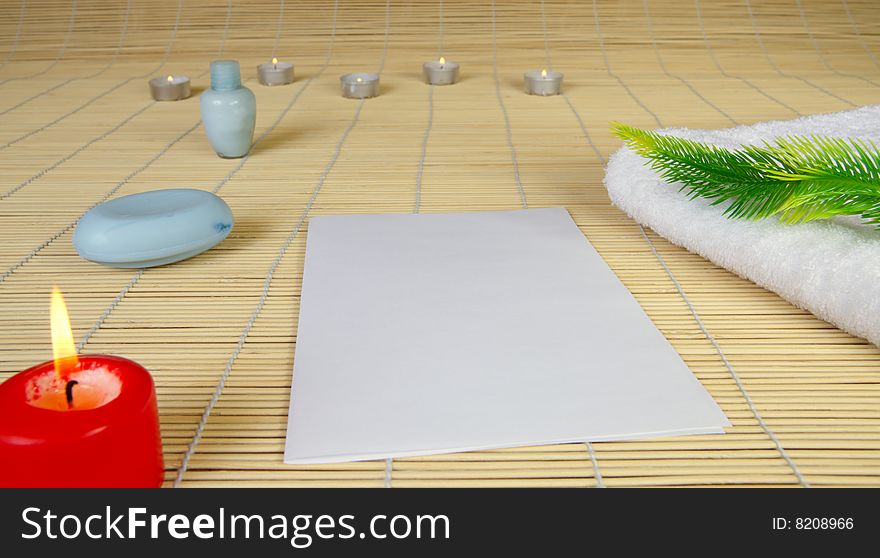 Spa objects. Candles, towel and paper.