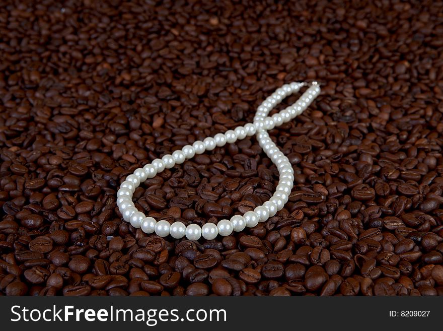 Pearl beads in coffee beans