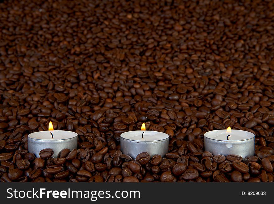 Thre candles in coffee beans