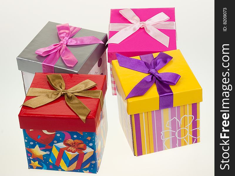 Various gift boxes on a white background, with bow