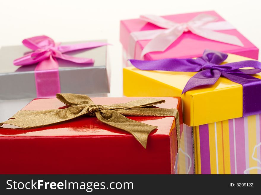 Various gift boxes on a white background, with bow