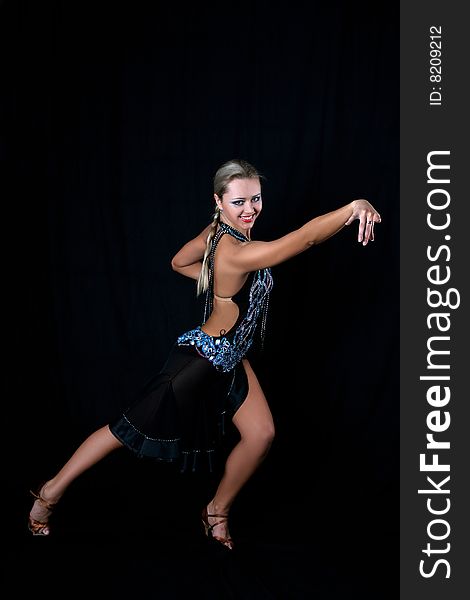 Lovely girl latino dancer against black background