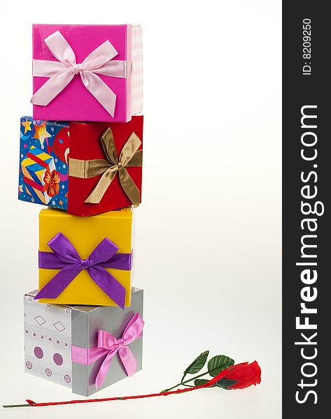 Various gift boxes on a white background, with bow and rose. Various gift boxes on a white background, with bow and rose