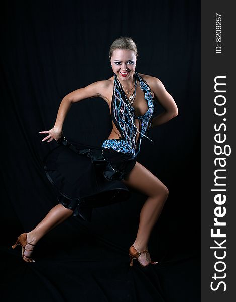 Blondie girl latin dancer against black background