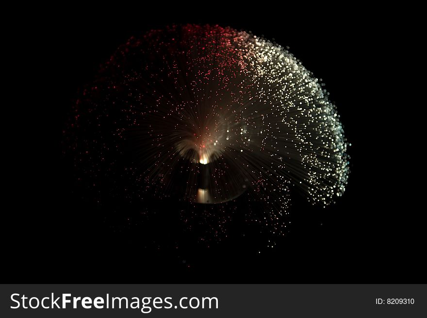 Red and white colored fiber glass lamp on a black background. Red and white colored fiber glass lamp on a black background