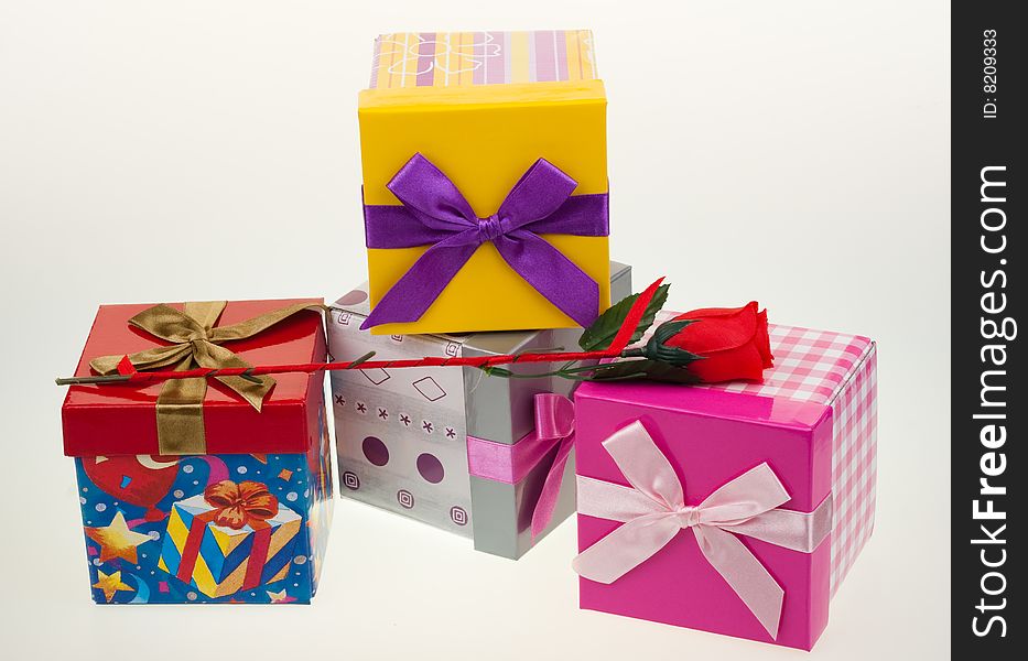 Various gift boxes on a white background, with bow and rose. Various gift boxes on a white background, with bow and rose