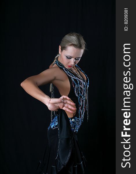 Lovely blond latin dancer against black background